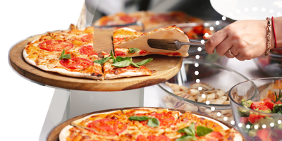 A plate of assorted bruschetta topped with various ingredients, like tomatoes and cheese, on a white surface.