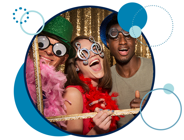 Two men and two women posing with fun costumes at a photobooth